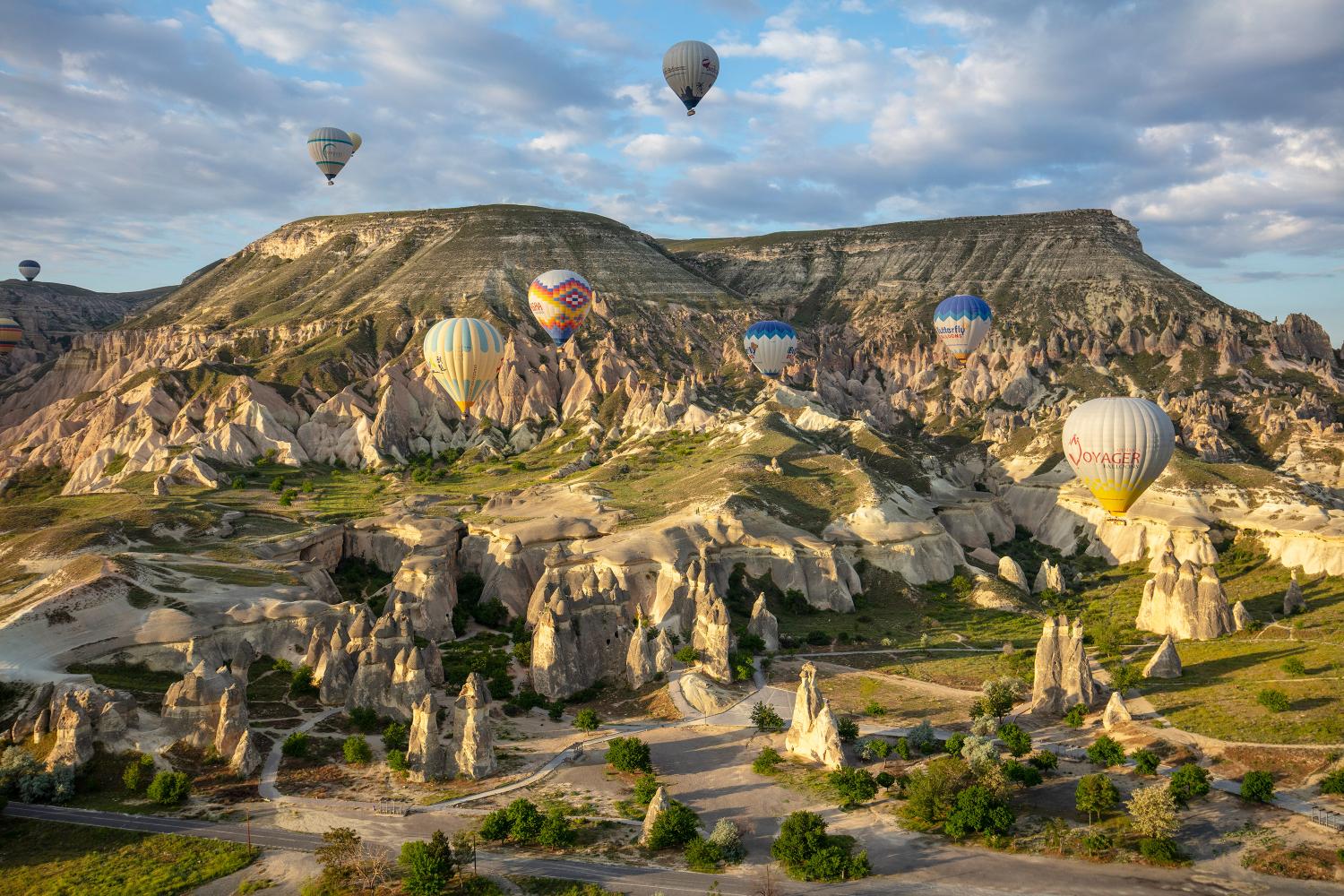 Hot air balloons floating over fairy chimneys.