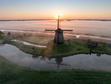 Aerial view of windmill at sunrise