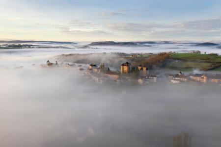 Curemonte in the morning mist in the autumn, Correze, France