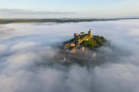 Aerial view of Turenne surrounded by mist at sunrise, Correze, France