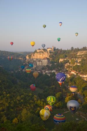 Hot air balloons fly over Rocamadour, Lot, France