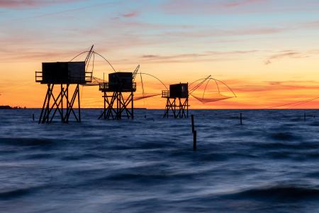 Stilt fishing huts at sunset, Atlantic Coast, France